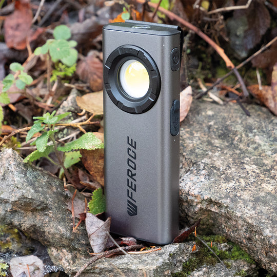 Lampe torche LED rechargable support magnétique FEROCE posée en forêt